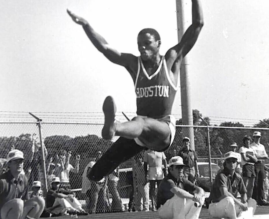 Carl Lewis in midair during a long jump for track and field as an athlete at the University of Houston