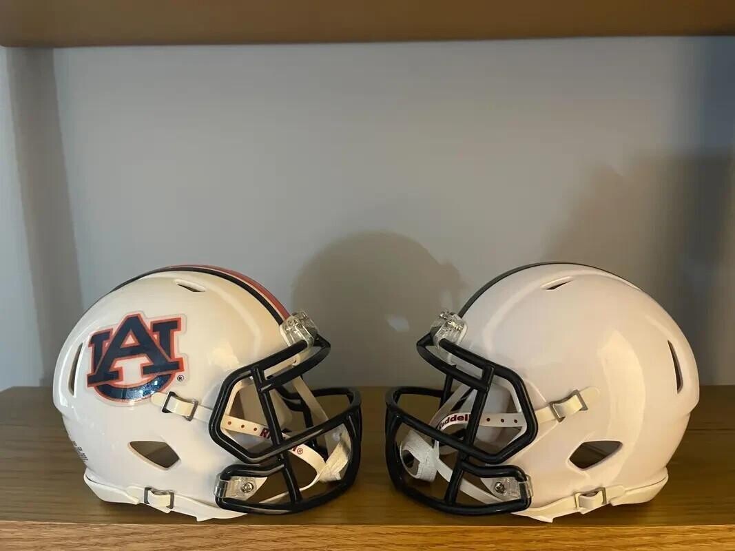Penn State and Auburn football helmets facing each other