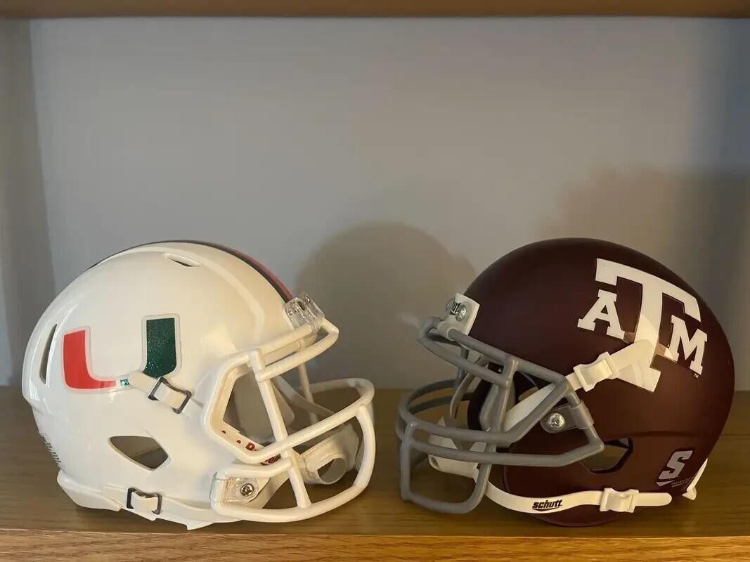 Miami and texas college football helmets facing each other