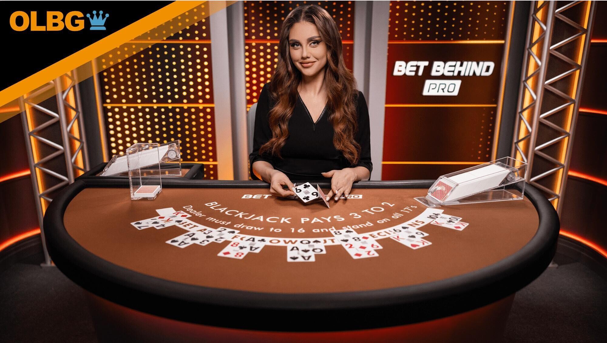 A female dealer dishes out the cards at the Bet Behind Pro Blackjack table