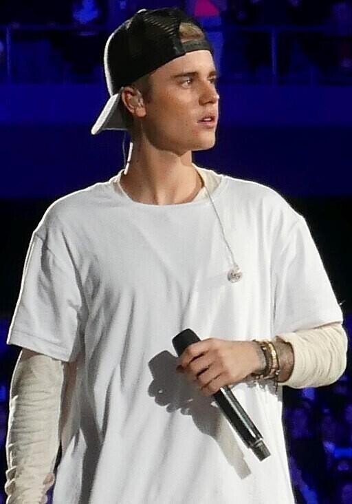 Justin Beiber, Canadian teenage heartthrob on stage dressed all in white