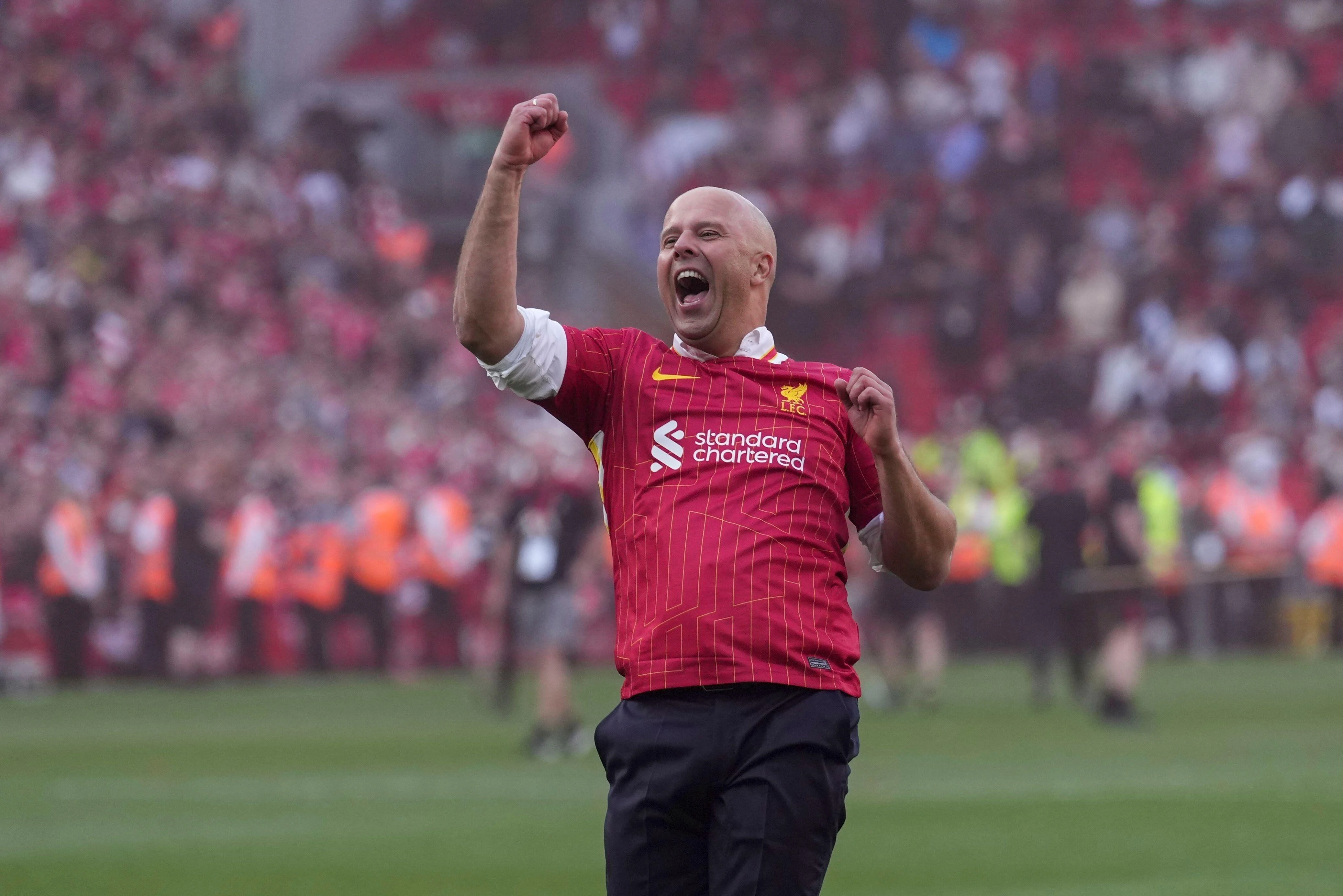 Liverpool's manager Arne Slot celebrates after winning the English Premier League soccer match between Liverpool and Tottenham Hotspur and clinching the Premier League title at Anfield in Liverpool, England