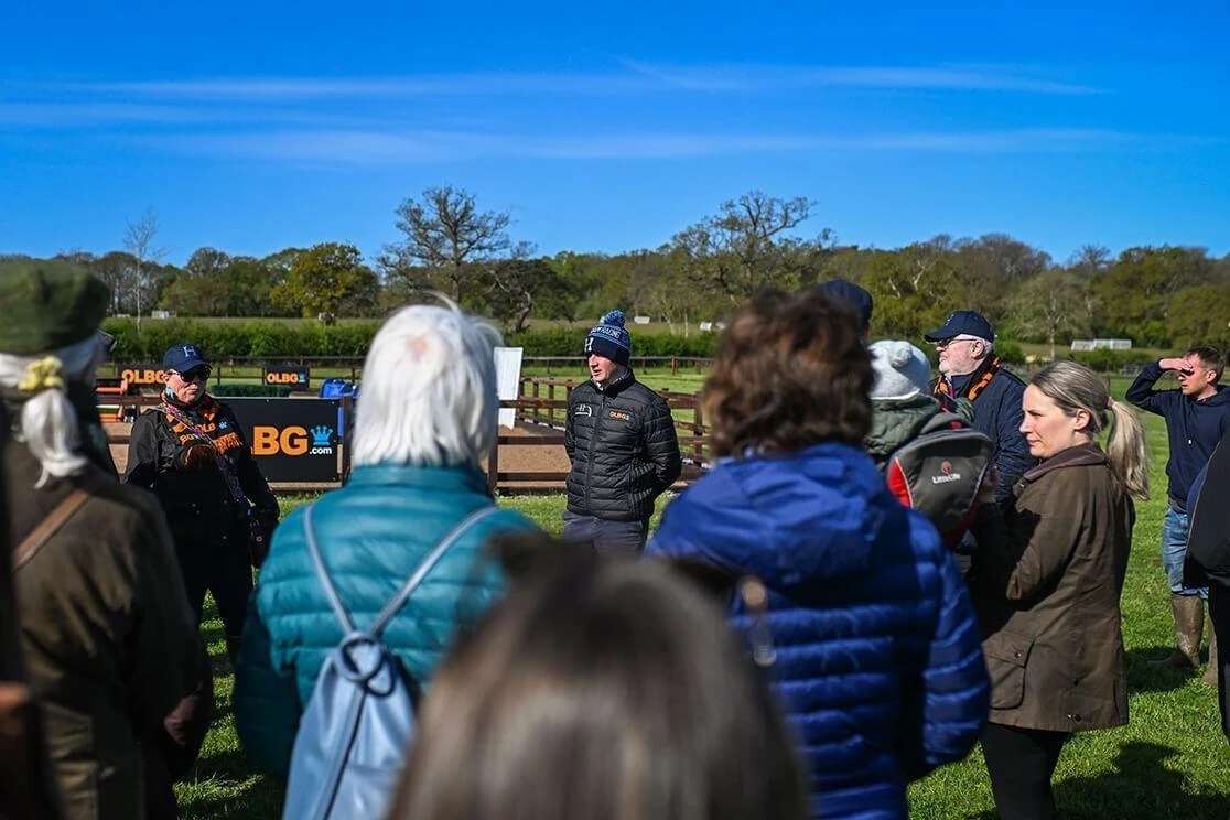 Harry Derham talking with members of the OLBG Racing Club during a yard visit 