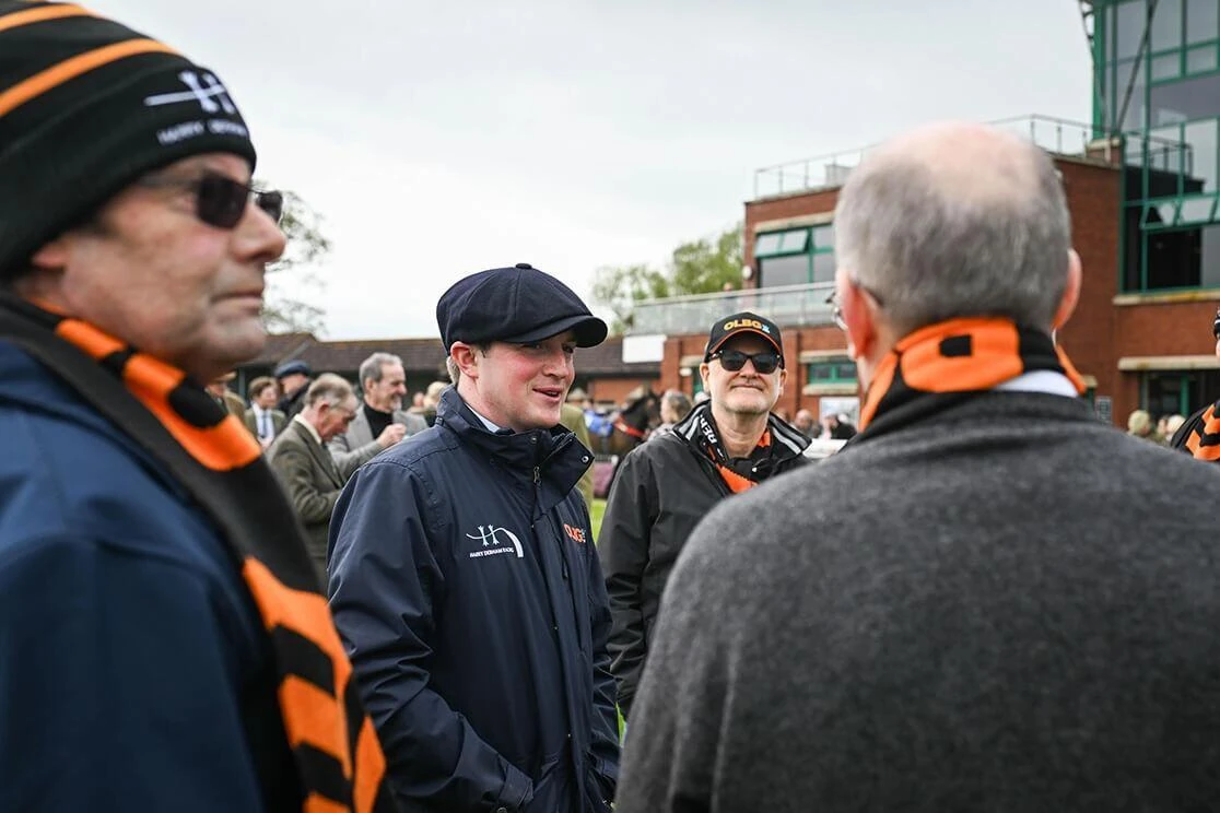 Members of the OLBG Racing Club talking to Harry Derham in the parade ring ahead of an OLBG Racing Club horse running