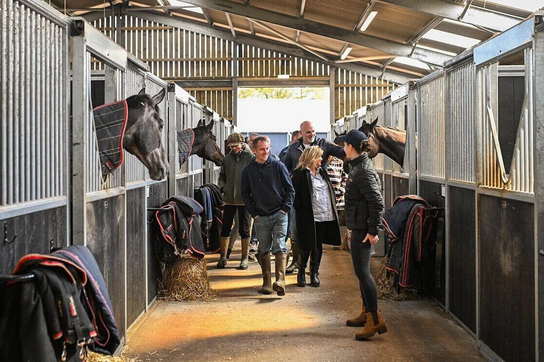 Members of the OLBG Racing Club looking round the yard at Harry Derham Racing