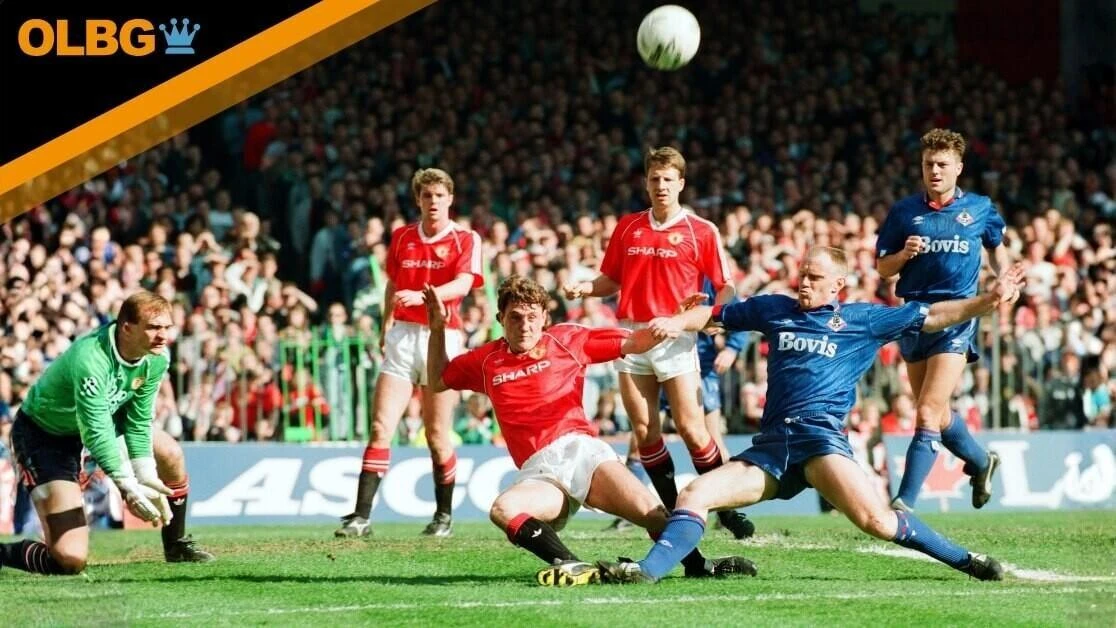 Steve Bruce tries to keep out Andy Ritchie. FA Cup. Manchester United 3 v Oldham Athletic 3. 8th April 1990